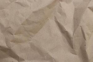Battered cardboard filling background. Crumpled paper texture. photo