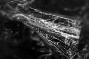 Drawing of the glowing rays of the sun on crumpled cellophane. Filling background. photo