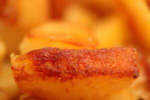 Fry potato texture. Fried potatoes slices filling background. photo