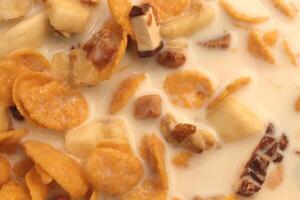 Cornflakes with chocolate sliced banana and milk. Filling background. Macro close-up. photo