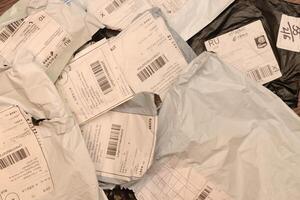Many post packets with labels filling background. photo