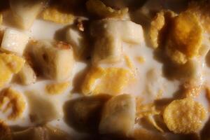 Muesli with cornflakes banana ind milk texture. Morning breakfast background. photo