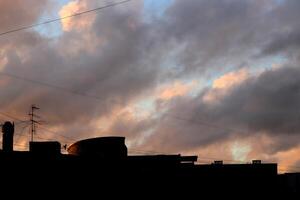 Building silhouette on sky clouds background photo