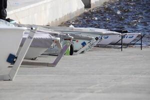 Row of prows of yachts stand on a slope ready to race photo
