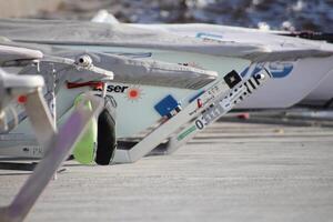 Row of prows of yachts stand on a slope ready to race photo