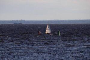 The sailboat reached the finish line buoys photo