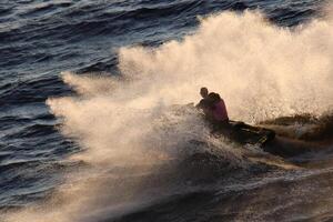 Active and energetic riding on a jet ski. Lots of splashes. Sports action. photo