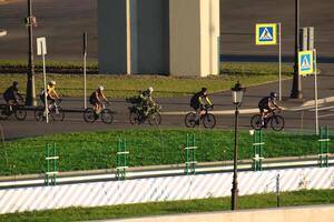 A group of cyclists crosses the construction of the city line of the Gulf of Finland photo