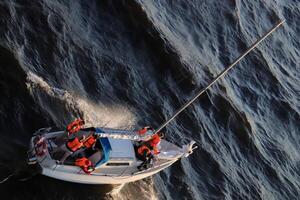 Sailing yacht with crew in vests crosses the waters of the Gulf of Finland photo