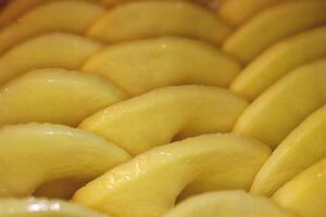 Loop slices potatoes backdrop. Raw spiral potato background. Vegetable cook idea. photo