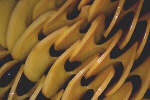 Vegetable cook idea. Loop slices potatoes backdrop. Raw spiral potato background. photo