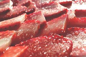 Tasty delicious background. Strawberry slices with sugar. Sweet Berry background. photo