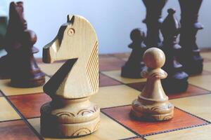 White horse and pawn chess figures background. Wood game chessboard. photo