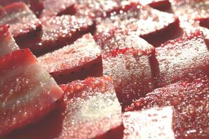 Strawberry with sugar texture. Vitamin berry backdrop. Strawberry slices in sugar filling background. photo