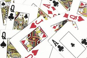Assorted play cards backdrop. Many miscellaneous jumbled playing cards surface. Mixed playing cards background. photo