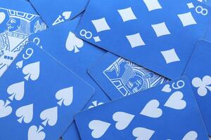 Many miscellaneous jumbled blue playing cards surface. Mixed playing cards background. Assorted play cards backdrop. photo