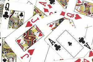 Mixed playing cards background. Assorted play cards backdrop. Many miscellaneous jumbled playing cards surface. photo