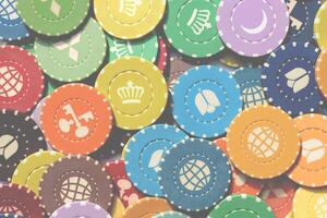 Colorful casino chips background. Many colored chips backdrop. Lot multicolor assorted gambling playing chips surface. photo