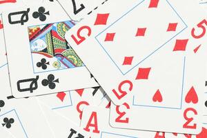 Mixed playing cards background. Assorted play cards backdrop. Many miscellaneous jumbled playing cards surface. photo