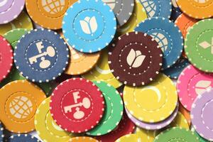 Many colored chips backdrop. Lot multicolor assorted gambling playing chips surface. Colorful casino chips background. photo
