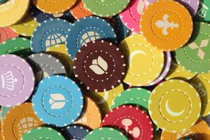 Many colored chips backdrop. Lot multicolor assorted gambling playing chips surface. Colorful casino chips background. photo