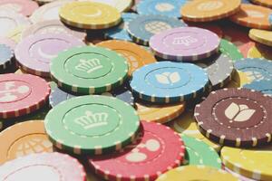 Lot multicolor assorted gambling playing chips surface. Colorful casino chips background. Many colored chips backdrop. photo
