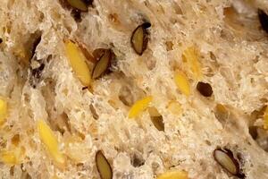 Flax seeds bread crumb texture. Diet food background. Fief grains bread crumb surface. photo