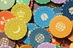 Lot multicolor assorted gambling playing chips surface. Colorful casino chips background. Many colored chips backdrop. photo