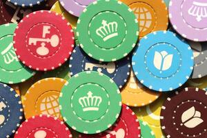 Colorful casino chips background. Many colored chips backdrop. Lot multicolor assorted gambling playing chips surface. photo