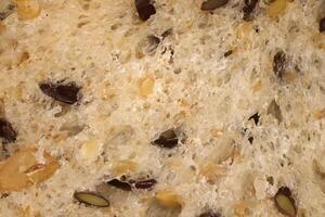 Diet food background. Fief grains bread crumb surface. Flax seeds bread crumb texture. photo