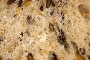 Flax seeds bread crumb texture. Diet food background. Fief grains bread crumb surface. photo