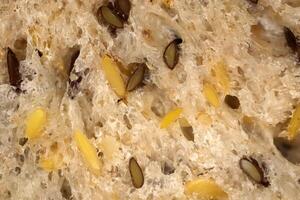 Fief grains bread crumb surface. Flax seeds bread crumb texture. Diet food background. photo
