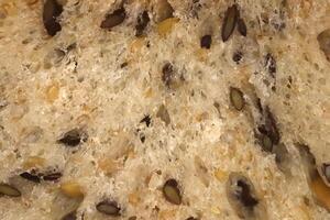 Diet food background. Fief grains bread crumb surface. Flax seeds bread crumb texture. photo