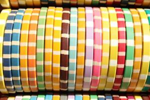 Lot multicolor assorted gambling playing chips surface. Colorful casino chips stack background. Many colored chips backdrop. photo