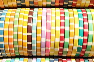 Many colored chips backdrop. Lot multicolor assorted gambling playing chips surface. Colorful casino chips stack background. photo