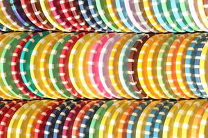 Many colored chips backdrop. Lot multicolor assorted gambling playing chips surface. Colorful casino chips stack background. photo