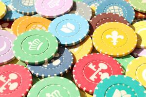 Lot multicolor assorted gambling playing chips surface. Colorful casino chips background. Many colored chips backdrop. photo