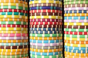 Colorful casino chips stack background. Many colored chips backdrop. Lot multicolor assorted gambling playing chips surface. photo