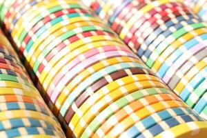 Colorful casino chips stack background. Many colored chips backdrop. Lot multicolor assorted gambling playing chips surface. photo