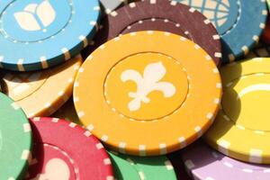 Colorful casino chips background. Many colored chips backdrop. Lot multicolor assorted gambling playing chips surface. photo