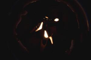 Few fire flame lights on the paraffin candle surface. photo