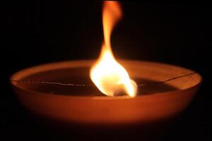 Dancing candle fire twinkle. Warm orange background. photo