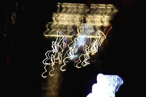 Night exposure shake traces background. Light lines leaks exposition backdrop. Night city rays glow texture. photo