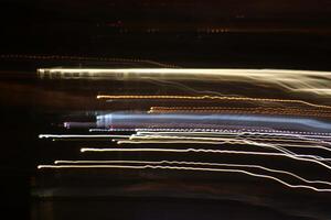 Night city rays glow background. Night exposure zoom traces backdrop. Light lines leaks exposition texture. photo