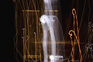 Night exposure zoom traces background. Light lines leaks exposition backdrop. Night city rays glow texture. photo