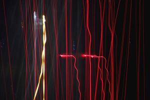 Night exposure zoom traces background. Light lines leaks exposition backdrop. Night city rays glow texture. photo