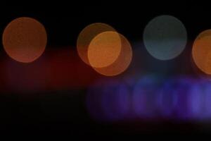Blurred colored lights background. Lens bokeh backdrop. Flare color lights overlays. Abstract bright blurred colored bokeh. photo