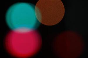 Abstract bright blurred colored bokeh. Blurred colored lights background. Lens bokeh backdrop. Flare color lights overlays. photo