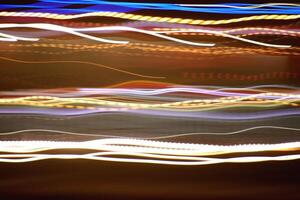 Night exposure zoom traces background. Light lines leaks exposition backdrop. Night city rays glow texture. photo