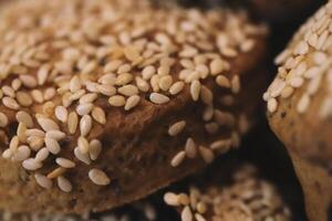 Freshly baked date cookies sprinkled with sesame seeds. Macro closeup. photo